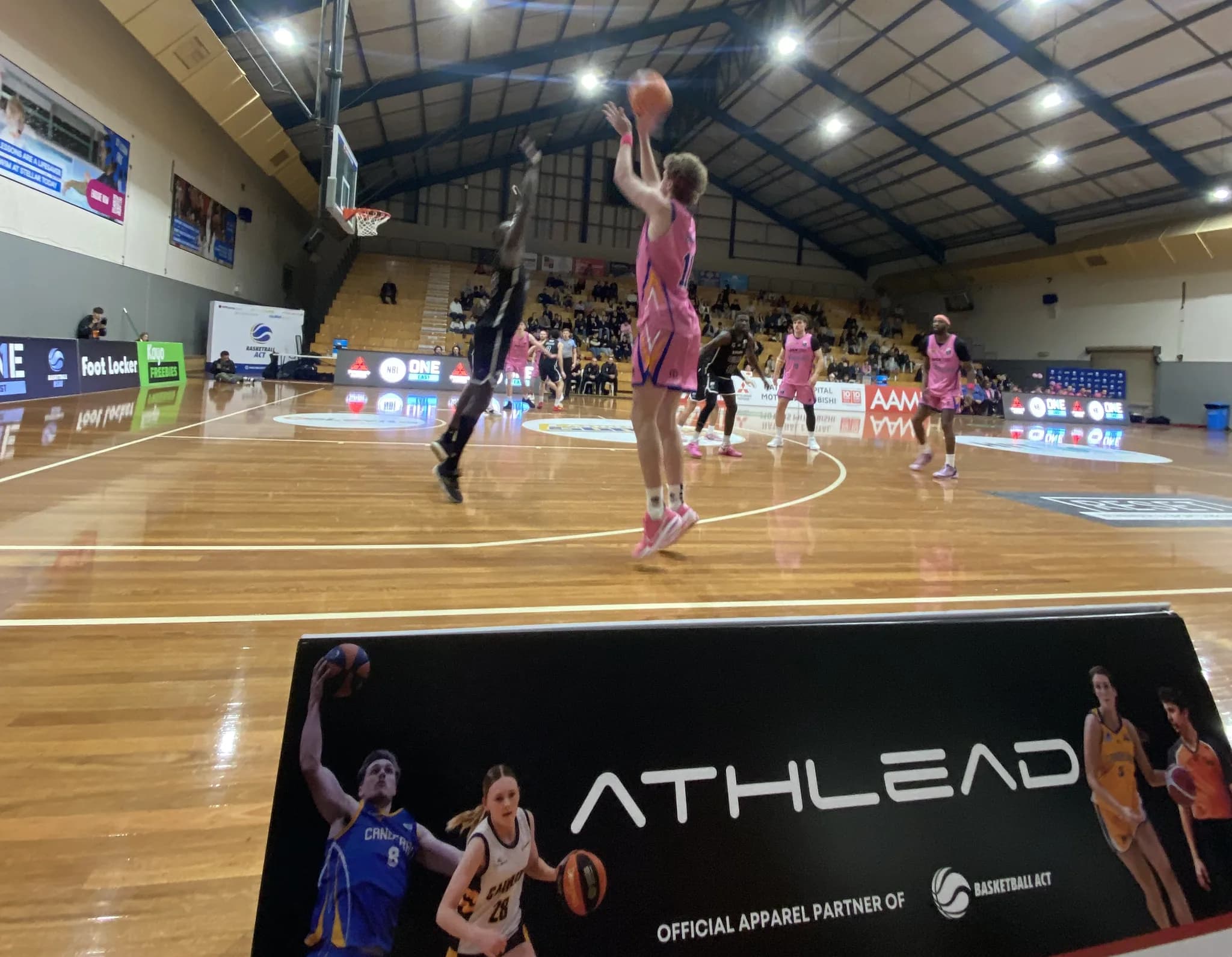 A player rising for a shot in club teamwear